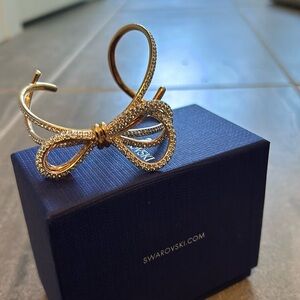 Swarovski cuff with a bow and faux diamonds.  Metal plating is rose gold